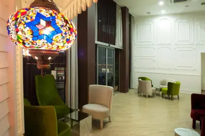 a waiting room with a colorful chandelier and chairs at Birbey Hotel in Istanbul