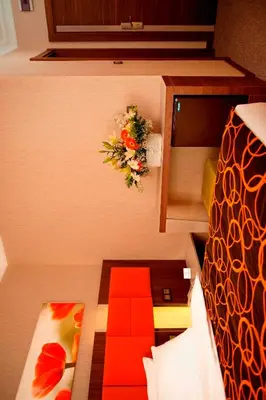 a small room with a bed and a flower arrangement on the wall at Birbey Hotel in Istanbul