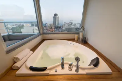 a bath tub in a bathroom with a window at Seminal Hotel Taksim in Istanbul