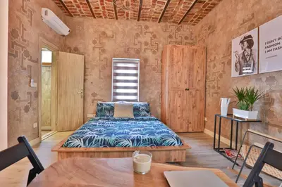 a bedroom with a bed and a table at Flats Company -Mujgan Apartment in Istanbul