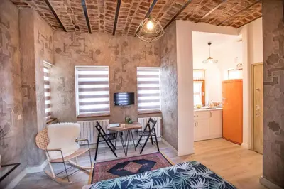 a living room with a table and chairs at Flats Company -Mujgan Apartment in Istanbul