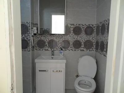 a bathroom with a toilet and a sink and a mirror at Tulip Guesthouse in Istanbul