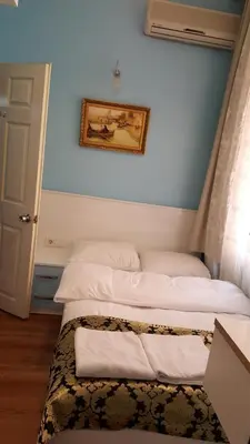 a pair of beds in a room with a window at Tulip Guesthouse in Istanbul