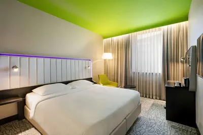 a bedroom with a white bed and a green ceiling at Park Inn by Radisson Istanbul Atasehir in Istanbul