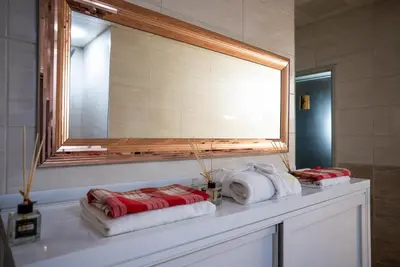 a bathroom with a mirror and towels on a counter at Mari Suites Hotel in Istanbul