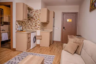 a living room with a couch and a kitchen at Mari Suites Hotel in Istanbul