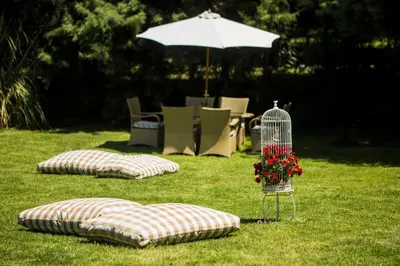 two pillows and a bird cage with flowers in the grass at Agva Greenline Guesthouse (Adult Only +12) in Agva