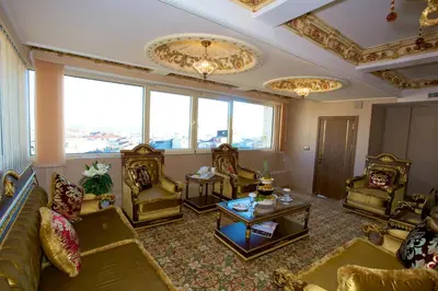 a living room filled with furniture and a large window at Marmaray Hotel in Istanbul