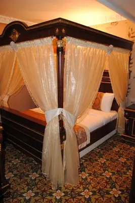 a bedroom with a canopy bed with curtains at Marmaray Hotel in Istanbul