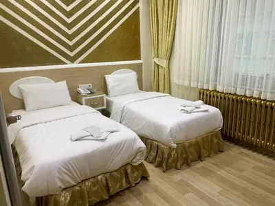 a hotel room with two beds with towels on them at Grand Oral Hotel in Istanbul