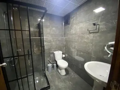 a bathroom with a shower and a toilet and a sink at Grand Oral Hotel in Istanbul