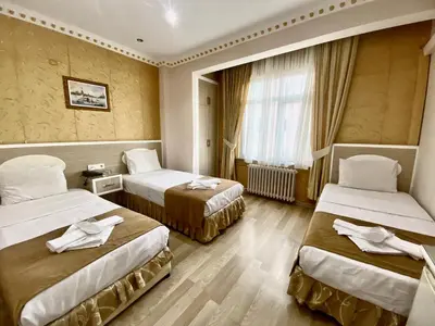 a hotel room with two beds and a window at Grand Oral Hotel in Istanbul