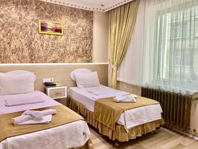a hotel room with two beds and a window at Grand Oral Hotel in Istanbul