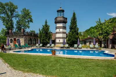 a lighthouse on top of a house with a pool at Wineport Lodge Agva Riverside Hotel & Winery in Agva