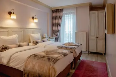 a hotel room with two beds and a window at Agora Guesthouse in Istanbul