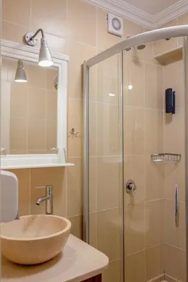 a bathroom with a sink and a glass shower at Agora Guesthouse in Istanbul