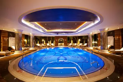 a large pool in a hotel with chairs around it at Limak Yalova Thermal Boutique Hotel in Gokcedere