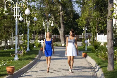 two women walking down a sidewalk in a park at Limak Yalova Thermal Boutique Hotel in Gokcedere
