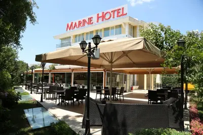 a restaurant with tables and chairs under an umbrella at Pendik Marine Hotel in Istanbul