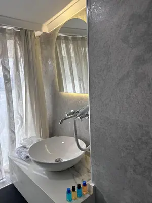 a bathroom with a white sink and a mirror at Pendik Marine Hotel in Istanbul