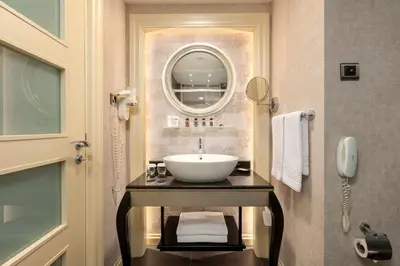a bathroom with a sink and a mirror at Limak Eurasia Luxury Hotel in Istanbul