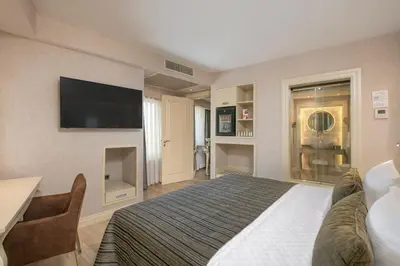 a hotel room with a bed and a flat screen tv at Limak Eurasia Luxury Hotel in Istanbul