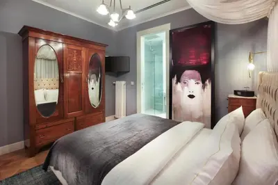 a bedroom with a large bed and a mirror at Lina Hotel Taksim Pera in Istanbul