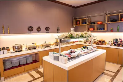 a kitchen with a buffet with plates and food at Ramada by Wyndham Istanbul Alibeykoy in Istanbul
