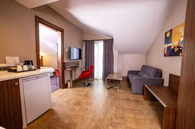 a living room with a couch and a table at Ramada by Wyndham Istanbul Alibeykoy in Istanbul