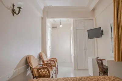 a room with three chairs and a tv on the wall at Hali Hotel in Istanbul