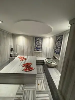 a bathroom with a toilet and a wooden table at Hotel Perula & SPA in Istanbul