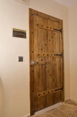 a large wooden door in the corner of a room at Hotel Perula & SPA in Istanbul