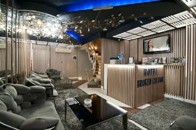 a living room with couches and a tv on a wall at Hotel Broken Column in Istanbul