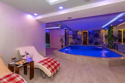 a pool in a room with a table and chairs at Bekdas Hotel Deluxe & Spa in Istanbul