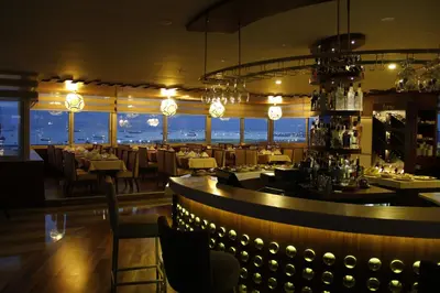 a restaurant with a bar with tables and chairs at Bekdas Hotel Deluxe & Spa in Istanbul