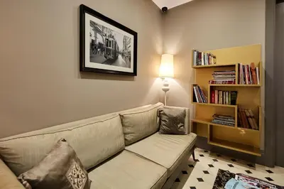 a living room with a couch and a book shelf at Taksim Prelude Hotel in Istanbul