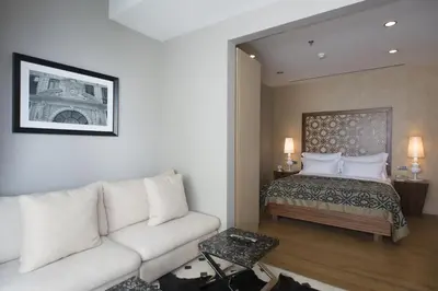 a living room with a couch and a bed at The Story Hotel Pera in Istanbul