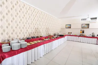 a row of tables with plates of food on them at Hotel Avcilar City in Avcılar