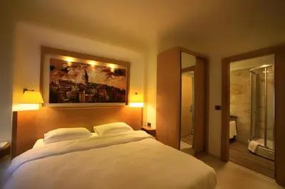 a bedroom with a white bed and a painting on the wall at Beyoglu MLS Hotel in Istanbul