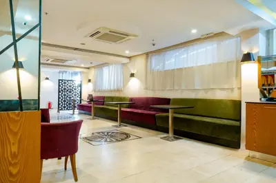 a restaurant with red and green benches and tables at Beyoglu MLS Hotel in Istanbul