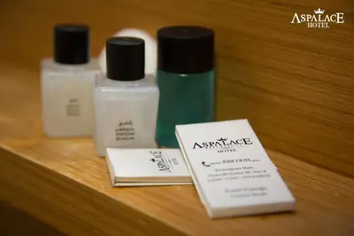 three bottles ofmetics sitting on a wooden table at Aspalace Hotel The Istanbul Old City in Istanbul
