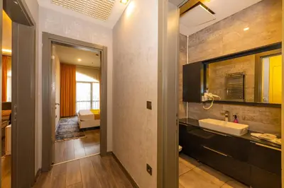 a bathroom with a sink and a mirror at Agora Suites in Esenyurt