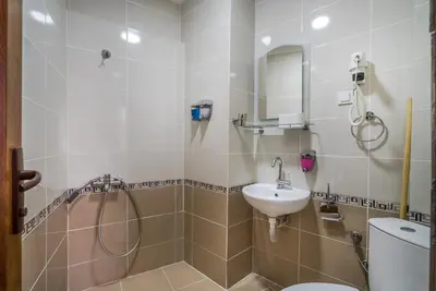 a bathroom with a shower and a toilet and a sink at Yeni Hotel in Istanbul