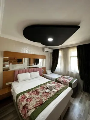 a bedroom with two beds and a table in it at Divas Silver in Istanbul