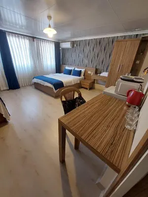 a bedroom with a bed and a wooden table at Aslan Home Apart in Istanbul