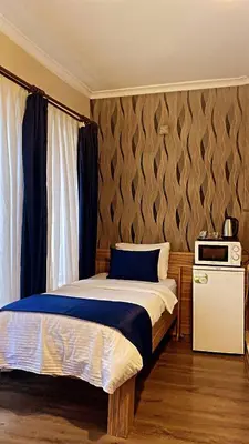 a bedroom with a bed and a microwave in it at Aslan Home Apart in Istanbul