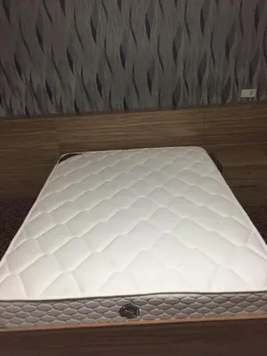 a white mattress sitting on top of a bed at Aslan Home Apart in Istanbul