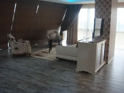 a living room with a couch and a tv at Golden Palas Hotel in Cerkezkoy