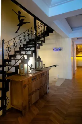 a staircase in a room with a wooden table and a stair case at Pearl Hotel İstanbul in Istanbul