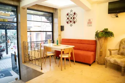 a dining room with a table and a couch at Pearl Hotel İstanbul in Istanbul